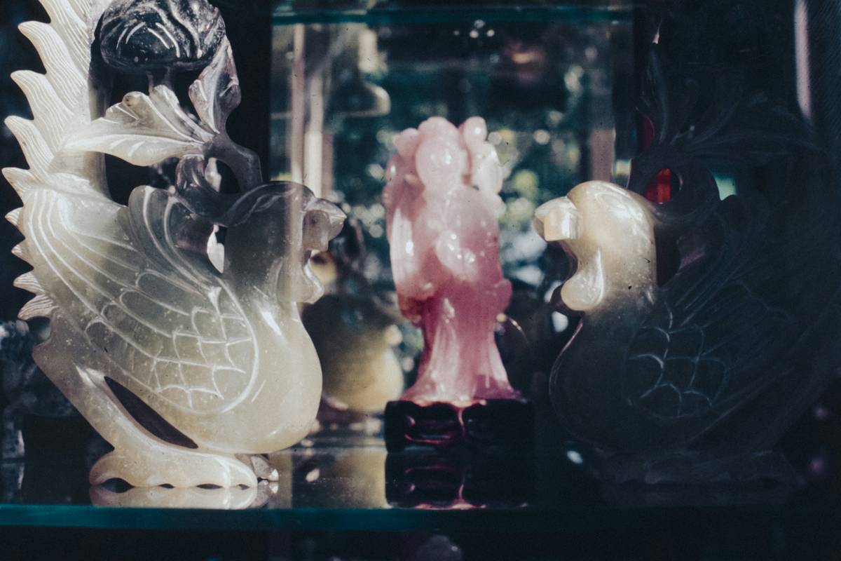 glass animal toys arranged on a soft cloth for gentle cleaning